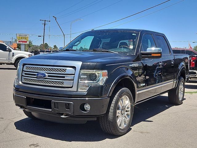 2013 Ford F-150 Platinum in Tuxedo Black Metallic — front three-quarter view